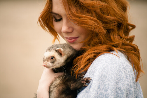 A woman with a ferret.