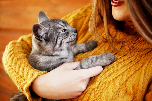 A woman hugging her cat.